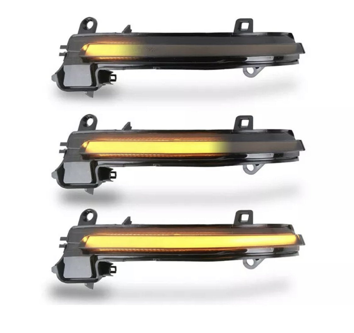 Three identical automotive LED sequential turn signal lights illuminate in a horizontal line, emitting an amber glow. They are mounted on a plain white background. No text is present.