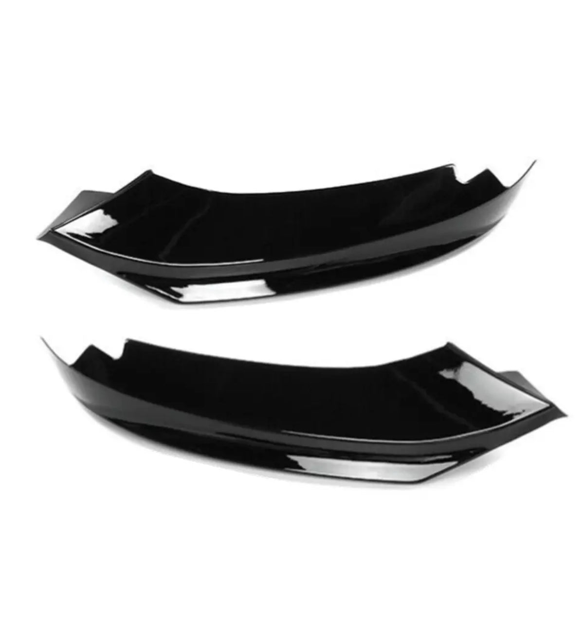 Two black, glossy aerodynamic car accessories lie side by side against a plain white background, showcasing their smooth, curved design and angular edges.