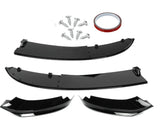 Black car bumper splitter kit with two curved panels, two smaller angular pieces, screws, and a roll of red tape; all arranged on a white background.