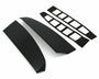 Two glossy black car spoiler pieces lay parallel, accompanied by two sets of adhesive strips with rectangular cutouts, all set against a plain white background.