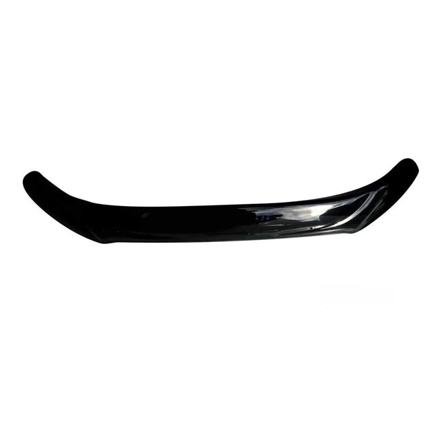 A glossy black car spoiler curving slightly upward lies against a plain white background, highlighting its sleek design and smooth surface.