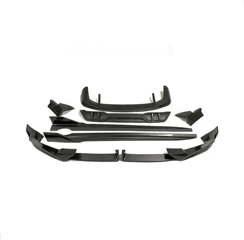 Car body kit parts arranged on a white background, featuring multiple angular black pieces designed for aerodynamic enhancement. Text reads "ABS Carbon Look."