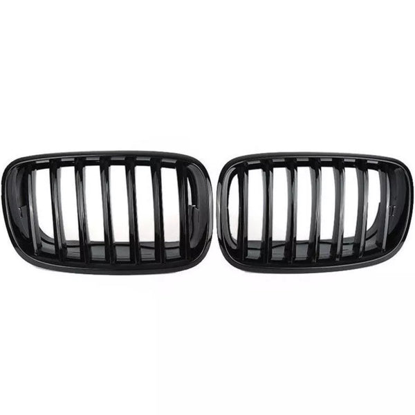 Two black car grilles with vertical slats are displayed side by side against a plain white background, showcasing a sleek automotive accessory design.