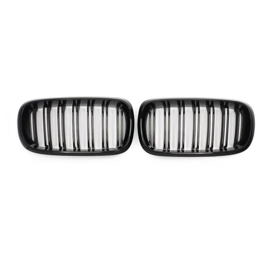 Two black kidney-shaped car grilles with vertical slats, positioned side by side on a plain white background.