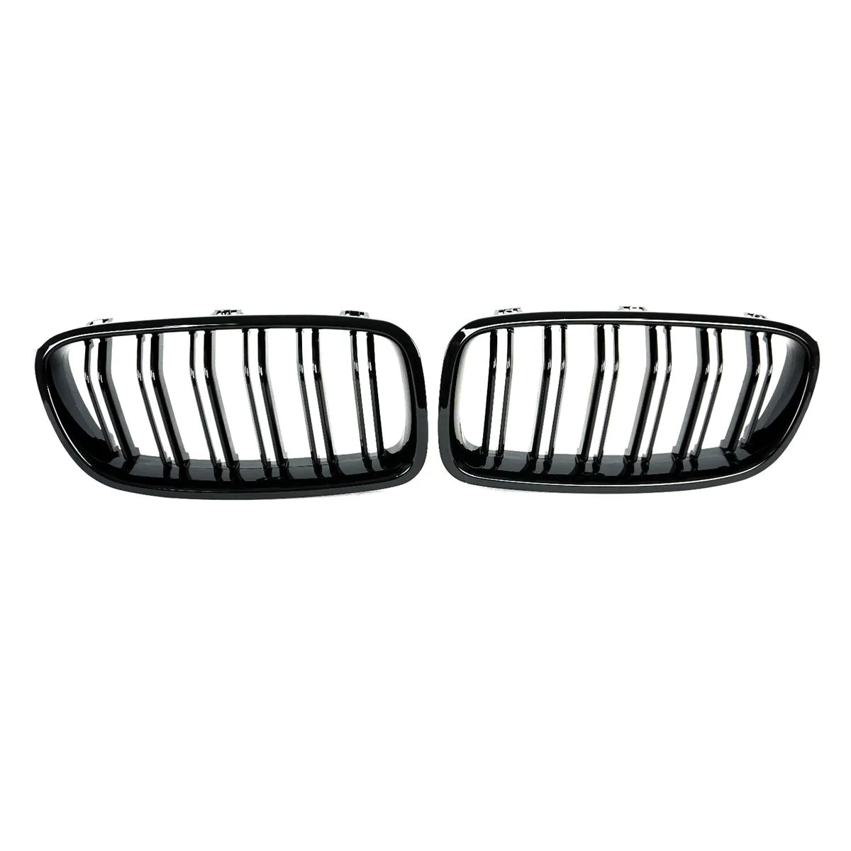 Two black, oval car grille inserts with vertical slats are positioned side by side against a plain white background.
