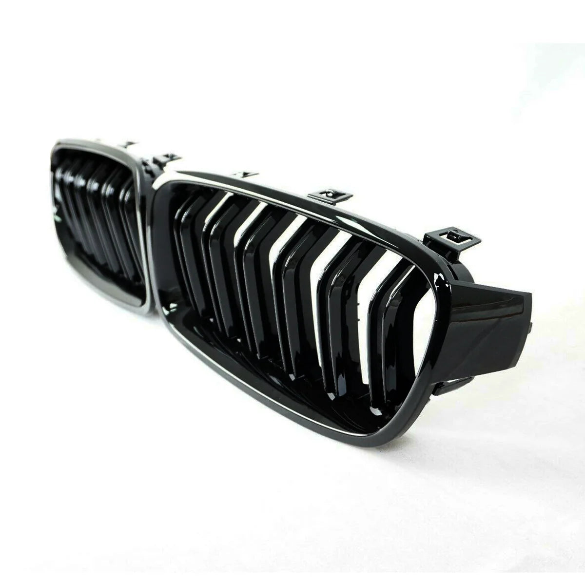 A glossy black car grille with vertical slats rests on a white background, showcasing sleek, modern automotive design.
