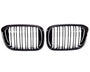Two sleek, black car grilles with vertical slats are positioned side by side against a white background, suggesting a symmetrical, possibly automotive design focus.