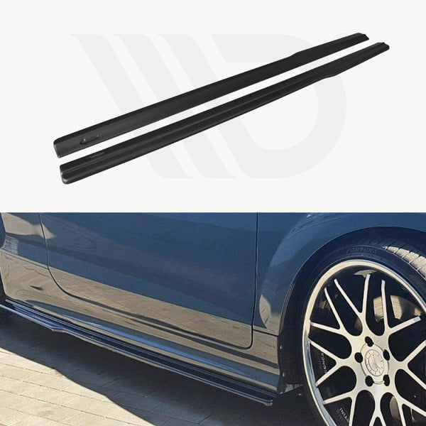 Two black car side skirts, photographed separately and also installed on a blue car with black and silver alloy wheels, parked on a brick surface.
