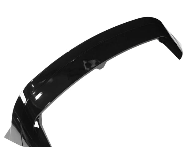 A glossy black car spoiler is shown on a plain white background, highlighting its aerodynamic curve and smooth surface.