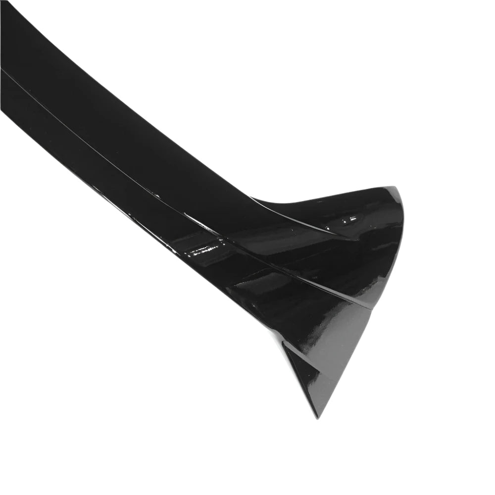 A glossy, black, aerodynamic car spoiler is displayed. It is angled and curved for minimizing drag, set against a plain white background, highlighting its sleek design.
