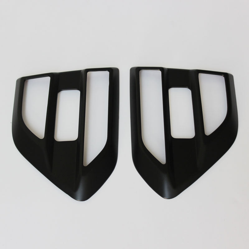 Two black, angular car air vent covers with rectangular openings positioned side by side on a white background.
