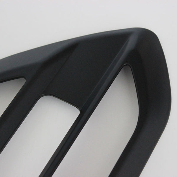 A black, angular car accessory with two rectangular openings is displayed on a plain white background.