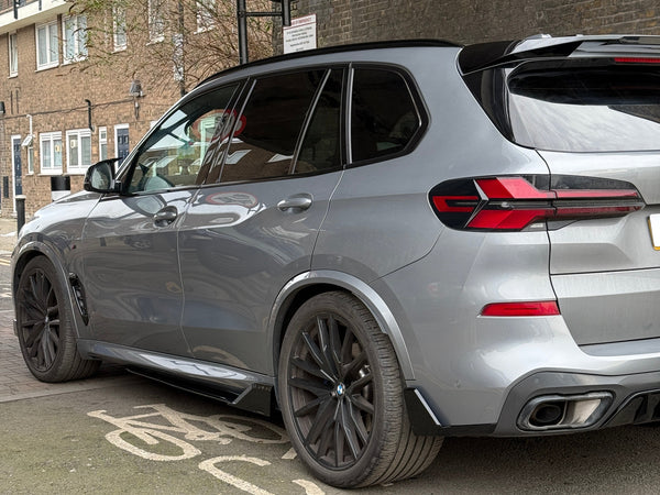 Gray SUV parked on a bicycle lane; under a street sign prohibiting motorcycles. Background features a brick wall and residential building with balconies.