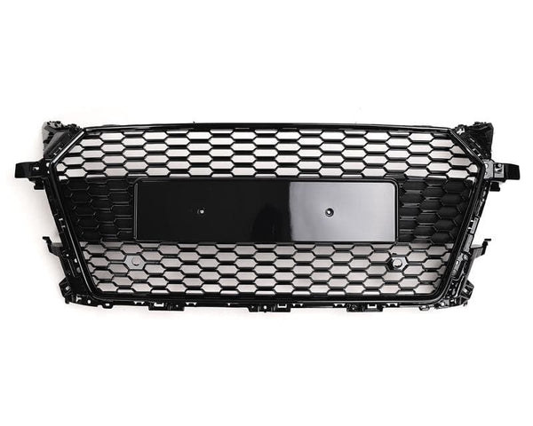 A black honeycomb-patterned car grille is displayed on a white background. It features a central rectangular area for a license plate or emblem.