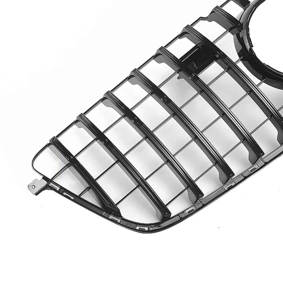 A glossy black car grille features horizontal slats and a circular opening, positioned against a plain white background.