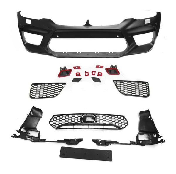 Assorted black car bumper parts, including a large bumper frame and multiple grilles, lay arranged on a white surface, showcasing components typically used in vehicle front-end assembly.