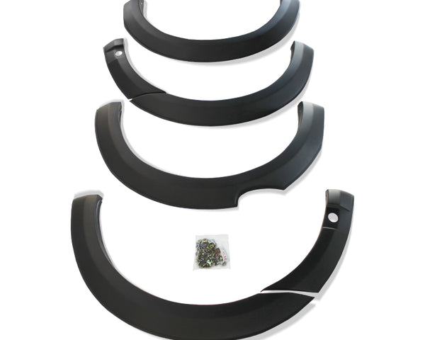 Four black car fender flares are arranged in descending size order. A small plastic bag containing screws lies in the center on a white background.