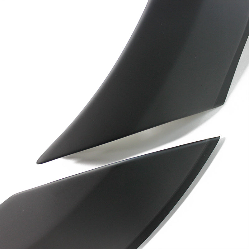 Two sleek, black, curved objects with pointed ends overlap slightly, set against a plain white background.