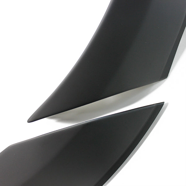 Two sleek, black, curved objects with pointed ends overlap slightly, set against a plain white background.