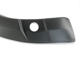 A black curved plastic car bumper cover with a circular hole, featuring angular lines, is set against a plain white background.