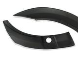 Curved black plastic car trim pieces are positioned on a plain white background, featuring a smooth finish and a circular hole on one piece.