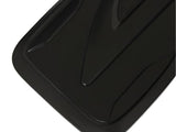 A black plastic tray features sleek, angular grooves and a shiny surface, positioned against a plain white background.