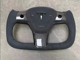 Rectangular steering wheel with a carbon-fiber design featuring the Tesla logo and 