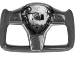 Steering wheel center; partially assembled carbon fiber; missing inner components; black grips. It has a sleek, modern design, suggesting use in high-performance vehicles or simulators. The background is plain white.