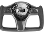 Steering wheel center; partially assembled carbon fiber; missing inner components; black grips. It has a sleek, modern design, suggesting use in high-performance vehicles or simulators. The background is plain white.