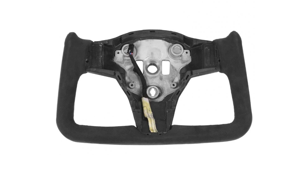 A rectangular black steering wheel with a metal center lacks buttons or features, set against a plain, white background.