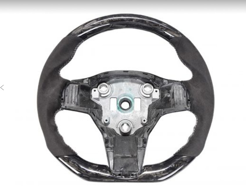 A black, partially upholstered car steering wheel with exposed metallic center; set against a plain white background, showing detailed construction and design elements.
