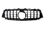 A black car grille with a grid pattern, featuring a central circular emblem area, is set against a plain white background.