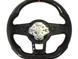 A black, textured carbon fiber steering wheel with a red stripe at the top. It is uninstalled, showing the metal frame and perforated sections for grip, on a white background.