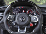 A Volkswagen steering wheel features multifunction controls, including 
