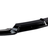 A black car front bumper spoiler, curved with vertical fins, is placed against a plain white background. It is designed to enhance aerodynamics and aesthetics.