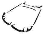 Black car body kit components are arranged on a plain white background. The pieces include bumpers and side skirts, designed to enhance vehicle aerodynamics and appearance.