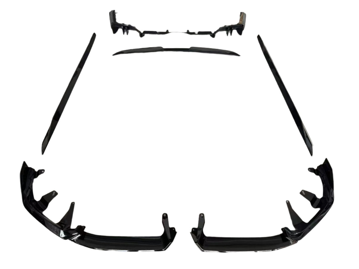 Individual black car body kit components are arranged symmetrically on a white background, including bumper pieces, side skirts, and a rear diffuser, designed for vehicle enhancement and protection.