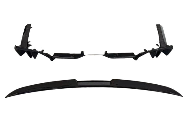 Two sleek black car parts, likely a bumper and a spoiler, are aligned parallel on a white background, showcasing their aerodynamic design and smooth surfaces.