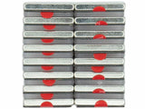 Rectangular metal tins are stacked in a 4x4 grid, each featuring a red semi-circle on the side, set against a plain white background.