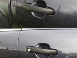 Top: A car door handle on a dark-colored vehicle lacks a keyhole. Bottom: Identical handle, same color, includes a visible keyhole. Both are in an outdoor setting.