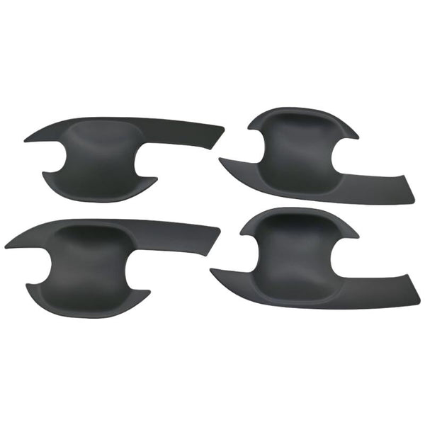 Four black, curved, plastic car door handle covers are positioned symmetrically on a plain background. They have an ergonomic design with cutouts for easy installation.