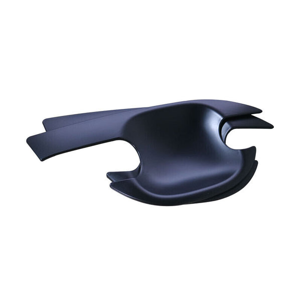 A sleek, black, abstractly designed chair with wide, wing-like armrests is set against a plain white background, emphasizing its modern and artistic form.