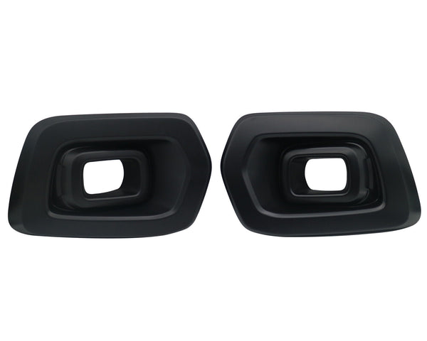 Two black exhaust tips with rectangular openings are facing forward. They are placed side by side against a plain white background.