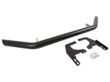 A black bull bar with curved ends lies next to two mounting brackets and a small bag of screws, set against a plain white background.
