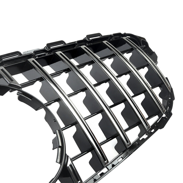 A shiny black car grille with vertical chrome slats, designed for vehicle front-end placement, lies against a white background, emphasizing its sleek, reflective surfaces and intricate detailing.