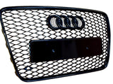 A black, honeycomb-patterned car grille featuring four linked rings at the top, with a rectangular placeholder for a license plate, set against a white background.