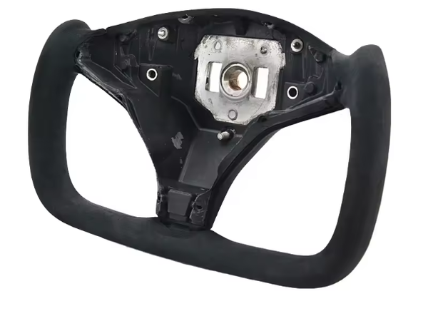A black, rectangular steering wheel frame with a central mounting area, shown against a plain white background. Several screw holes and a metal component are visible on the central section.
