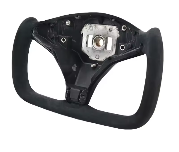 A black, rectangular steering wheel frame with a central mounting area, shown against a plain white background. Several screw holes and a metal component are visible on the central section.