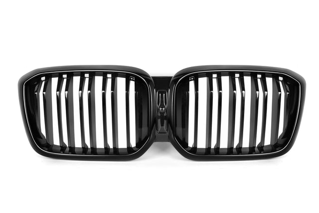 A black, dual kidney-shaped car grille with vertical slats is centered against a white background, highlighting its glossy finish and symmetrical design.