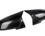 Two carbon fiber car mirror caps are displayed side by side on a plain white background, showcasing their glossy, textured finish and sleek aerodynamic design.